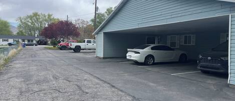 A garage with a white car parked inside.