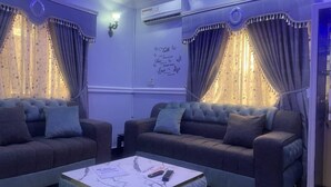 A living room with two sofas, a coffee table, and curtains. - Muniz Global Apartments  (Lagos)