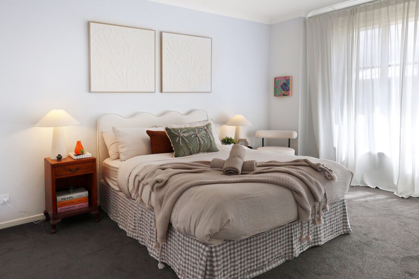 Spacious master bedroom with soft linens and plenty of natural light