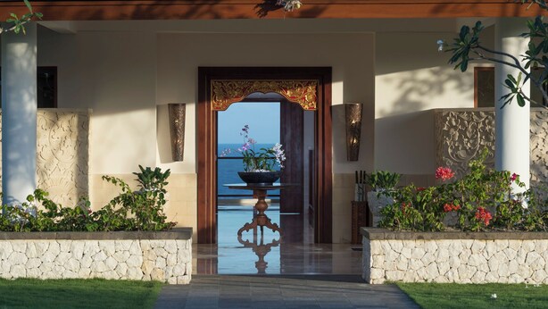 A grand entrance with a reflective floor, a decorative archway, and a view of the sea. - Villa Rose by Elite Havens (The Bukit)