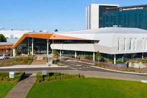 A modern building with a glass facade and a flat roof. - Modern Clyde House Smart TVDryer (Clyde)