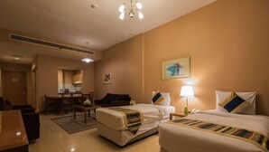 A hotel room with two beds, a desk, and a chair. - City Stay Grand Hotel Apartments - Al Barsha (Dubai)