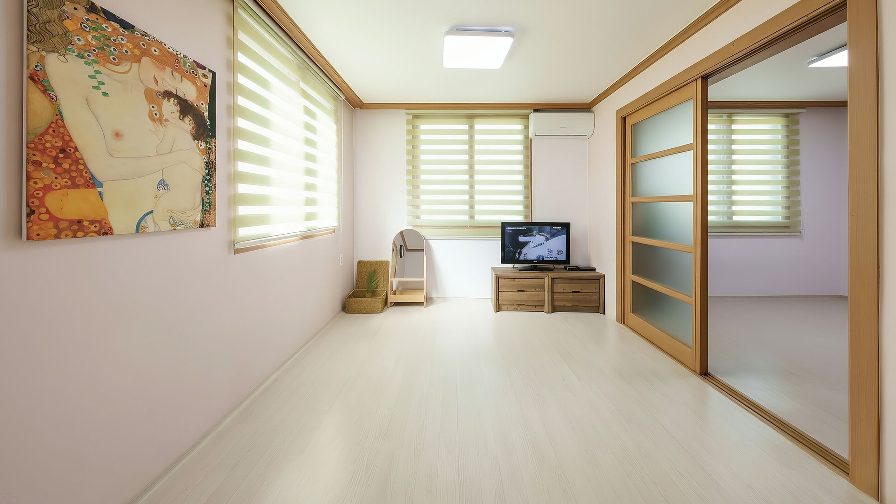 A room with a large mirror, a television, and a painting on the wall.