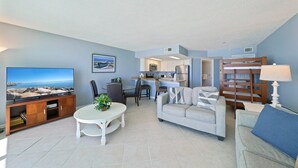 A living room with a TV, sofa, and dining area. - Enjoy Stunning Gulf Front Cabana Club 304! Private balcony with beautiful views! (Destin)