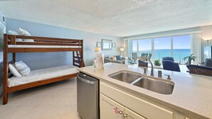 A compact kitchen with a built-in dishwasher, a double sink, and a small seating area with a view of the ocean. - Enjoy Stunning Gulf Front Cabana Club 304! Private balcony with beautiful views! (Destin)