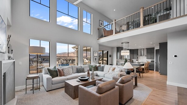 A spacious living room with a high ceiling, large windows, and a view of the mountains. - Deer Valley Views, 5br Sleeps 16, Hot Tub, Theater (Heber City)