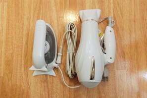 A white hair dryer and its accessories on a wooden surface. - Ryokan Asakusa-Chaka- by Tranova (Tokyo)