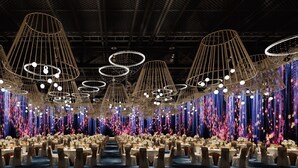 A large banquet hall with tiered seating and a central stage. - Hilton Garden Inn  (Suzhou)