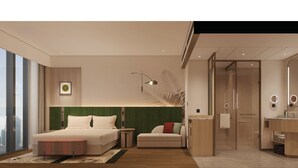 A modern hotel room with a large bed, a sitting area, a bathroom with a mirror, and a view of the city. - Hilton Garden Inn  (Suzhou)