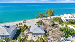 A coastal property with two main buildings, a beach, and palm trees. - 3BR Gulf-Front Luxury with Panoramic Views (Englewood)