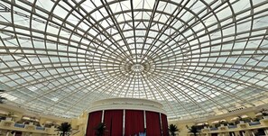 Un ampio atrio con soffitto in vetro e un'area centrale adibita a palcoscenico.