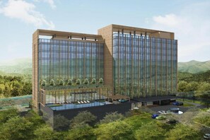 A modern hotel with a glass facade, a rooftop pool, and a landscaped garden. - Swissotel Nusantara (Bukit Subur)