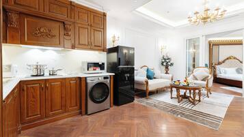 Suite, vista a la ciudad | Área de sala de estar | Televisión de 60 pulgadas con canales por cable