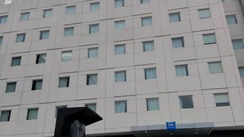 A multi-story hotel building with a uniform facade and numerous windows.