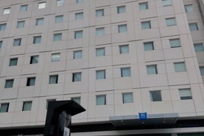 A multi-story hotel building with a uniform facade and numerous windows.