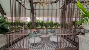 A cafe with a geometric patterned floor, green chairs, and a hanging gold chandelier. - Paxtonz KL Walk to Mall & Pool (Petaling Jaya)