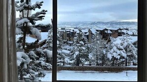 A snowy landscape with buildings and trees.