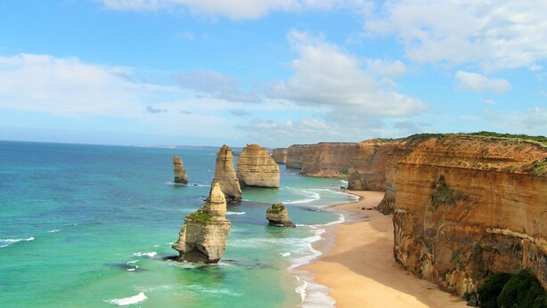 A coastal landscape with prominent rock formations and a sandy beach. - Ultra-Modern Coastal Living (Apollo Bay)
