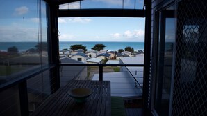 A balcony with a view of the sea and nearby houses. - Ultra-Modern Coastal Living (Apollo Bay)