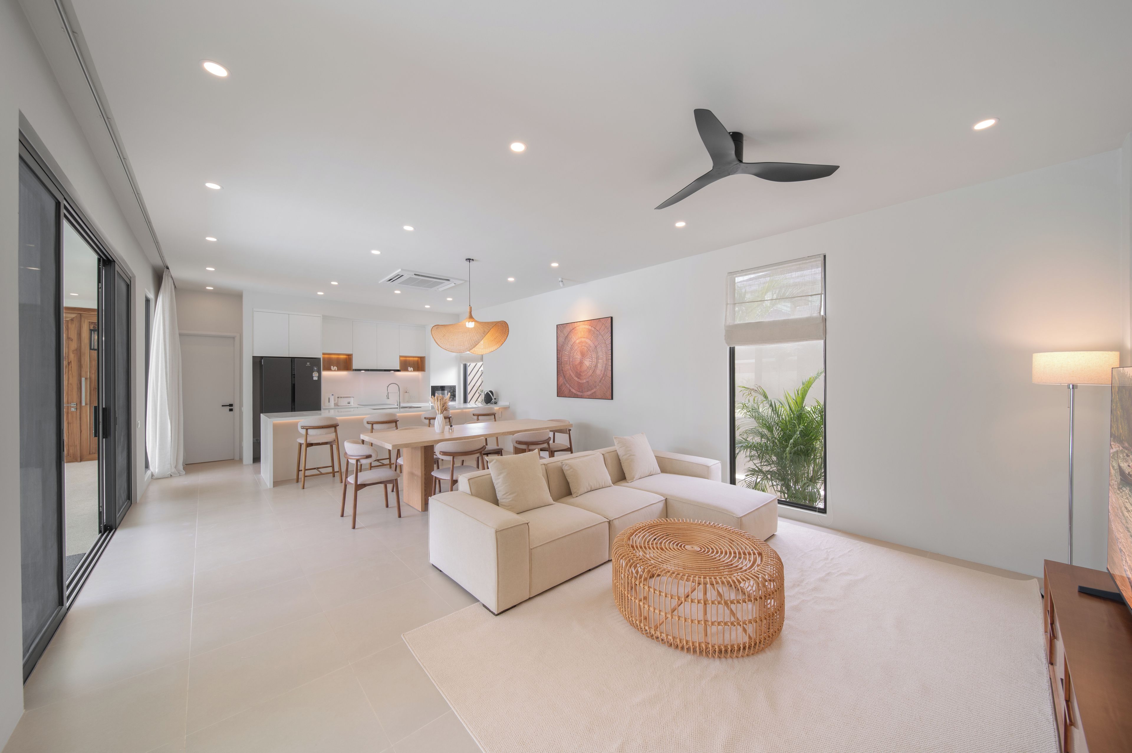 A modern interior with a dining area, kitchen, and living space.
