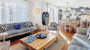 A modern living room with a sofa, coffee table, and dining area. - Villa Koraill Glaz by Interhome (Plouescat)