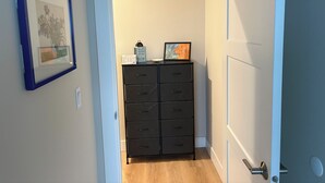 A hallway with a black filing cabinet, a framed picture on the wall, and a door on the right. - Hill top Oceanside Escape--30+days minimum! (Tillamook)