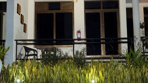A building facade with large windows, a fire extinguisher mounted on the wall, and a balcony with a railing. - Lovely 2-bedroom apartment in vibrant Kigali perfect for your stay (Kigali)