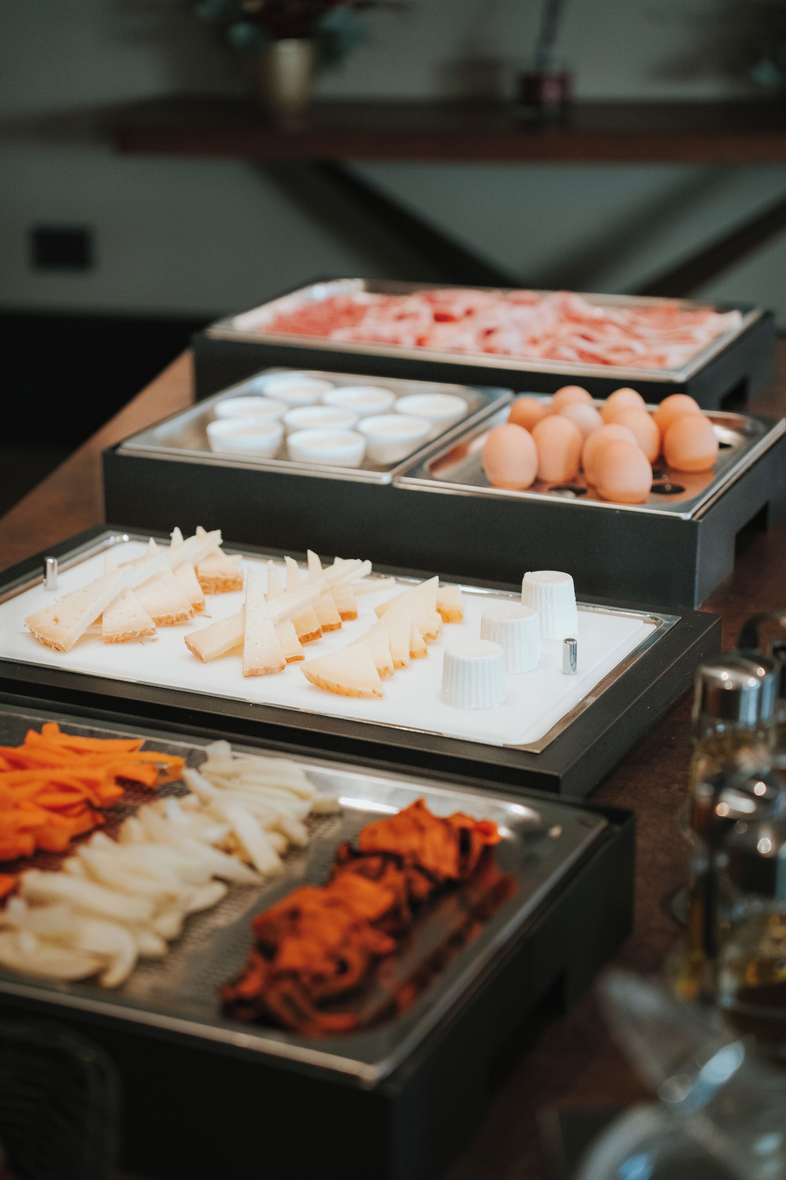 A buffet with various food items including seafood, eggs, and vegetables.