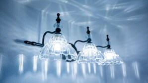 A chandelier with multiple glass shades and a black metal fixture. - Palmer Suite 101, Hyland Hotel (Palmer)