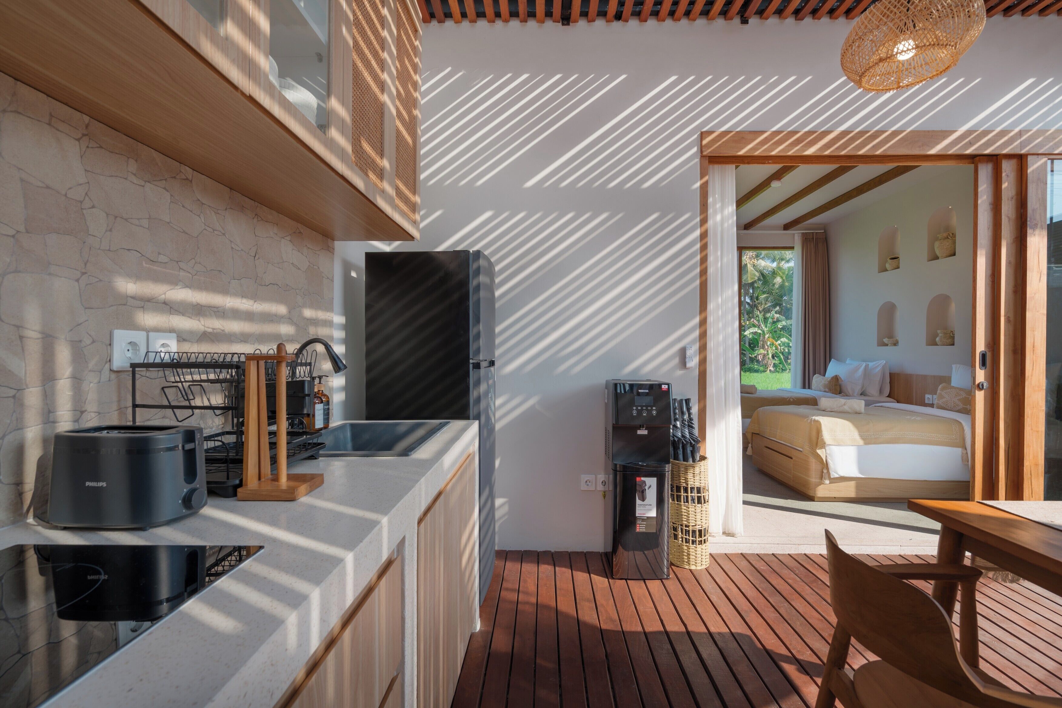 A modern kitchen with a built-in stove, a coffee machine, and a water dispenser.