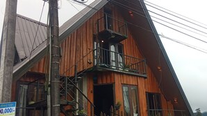 A wooden building with a balcony and a staircase. - The heaven wood cabin (Nuwaraeliya)
