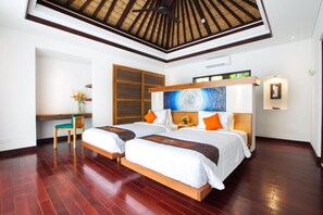 A hotel room with two beds, a desk, and a large window. - Sunset Paradise Villa Jimbaran 3003 (Kedonganan)