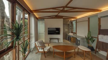 A modern interior with a large window, a wooden ceiling, a TV, and a seating area.