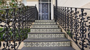 A set of black and white patterned steps leading to a door with a geometric design. - Cozy Studio With Balcony in Unbeatable Location (Sydney)