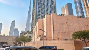 A cityscape with high-rise buildings, including a prominent skyscraper. - Studio Near Dubai Mall Burj Khalifa (Dubai)