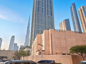 A cityscape with high-rise buildings, including a prominent skyscraper. - Studio Near Dubai Mall Burj Khalifa (Dubai)