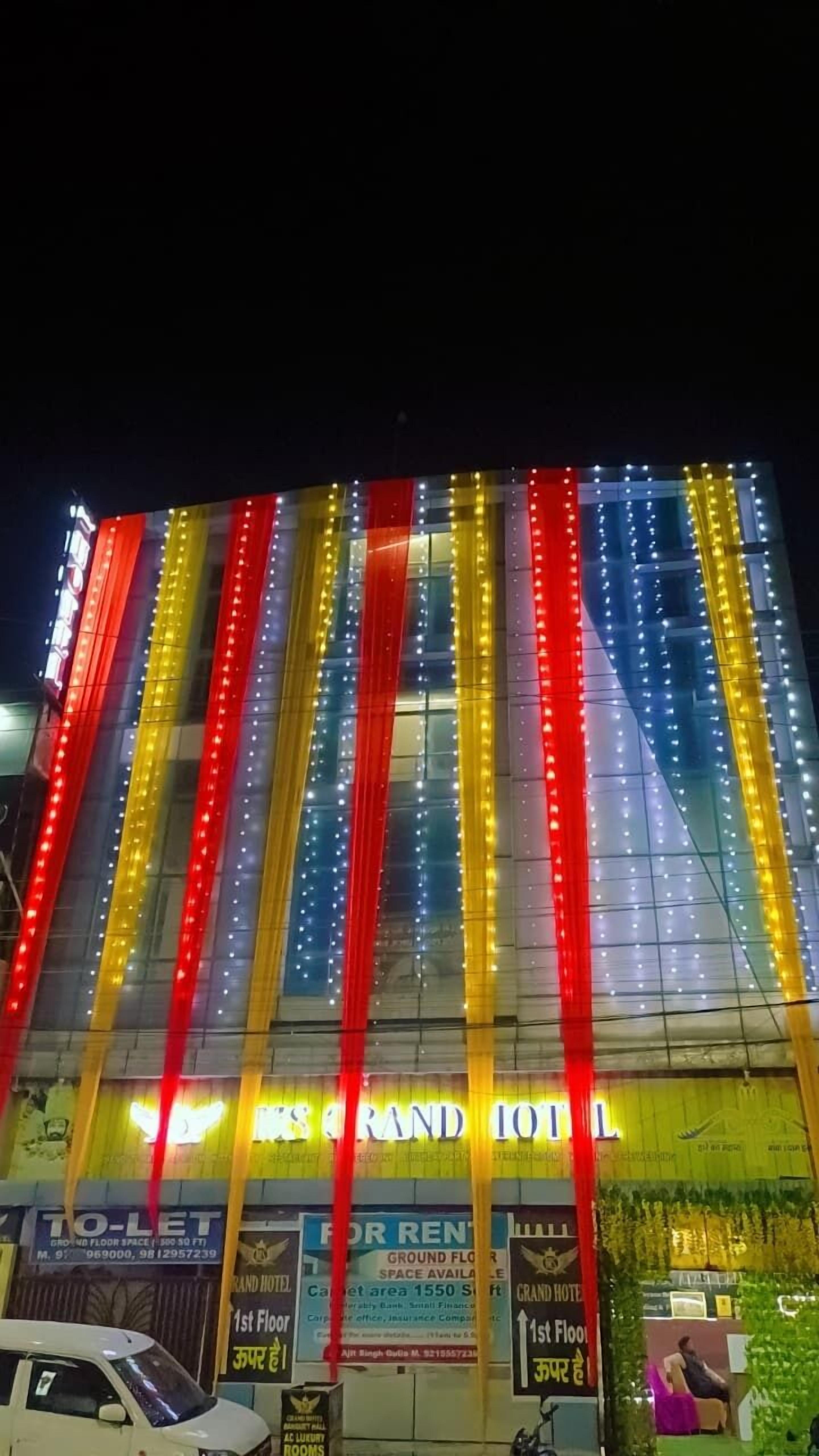 Een hotel met verticale lichtstroken in rood, geel en blauw.