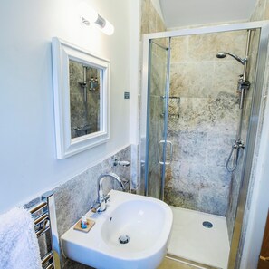 A bathroom with a white sink, a mirror, and a glass-enclosed shower. - The Stalls, scenic rural retreat near Durdle Door (Wareham)