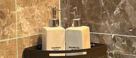 Shower, designer toiletries, hair dryer, bathrobes