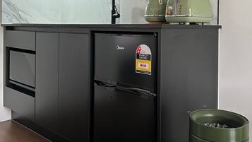 Mini-fridge, microwave, stovetop, cookware/dishes/utensils