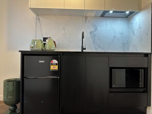 Mini-fridge, microwave, stovetop, cookware/dishes/utensils