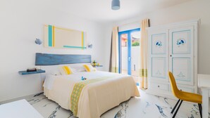 A bedroom with a bed, a desk, a chair, a wardrobe, and a window with curtains. - B&B Turchese House: Asia Room (Tortolì)