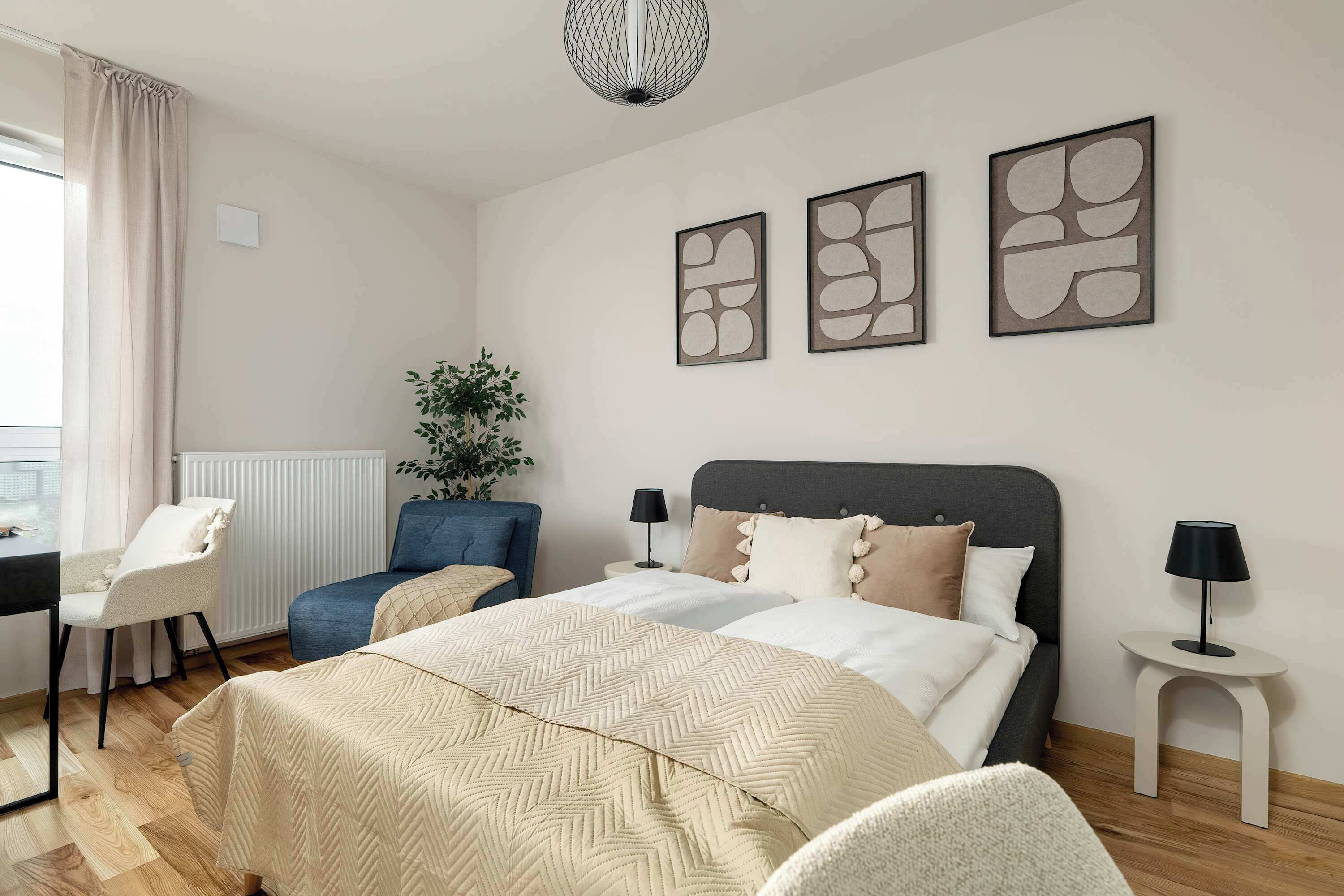 Bright bedroom area with a cozy double bed and soft neutral décor.