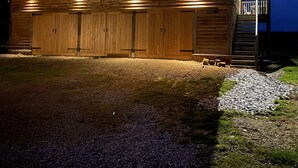 A wooden barn with two large doors and a staircase leading to a loft area. - Exclusive Couples retreat surrounded by beautiful North Devon countryside. (Burrington)
