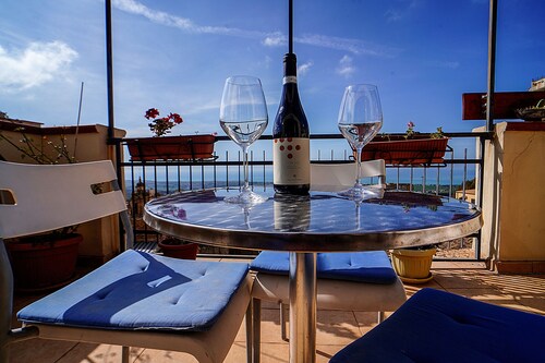 An ancient Sicilian house with a sea-view terrace in the heart of the city.