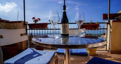 An ancient Sicilian house with a sea-view terrace in the heart of the city.
