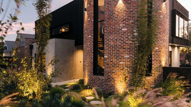 A modern building with a brick exterior, large windows, and a well-lit entrance. - Helix in Mornington With 4 Bedrooms and 3 5 Bathrooms (Melbourne)