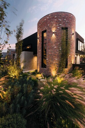 A modern building with a brick exterior, large windows, and a well-lit entrance. - Helix in Mornington With 4 Bedrooms and 3 5 Bathrooms (Melbourne)