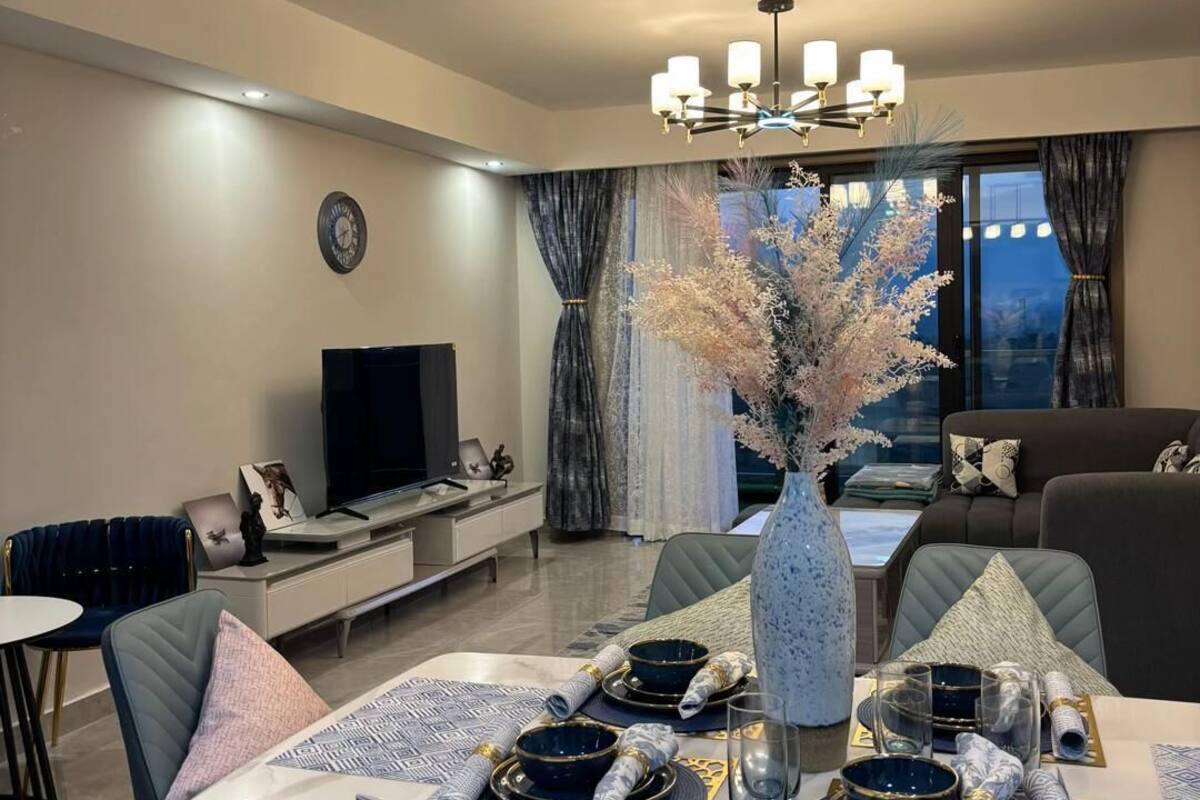 Family Apartment, City View | Living area | 32-inch Smart TV with digital channels