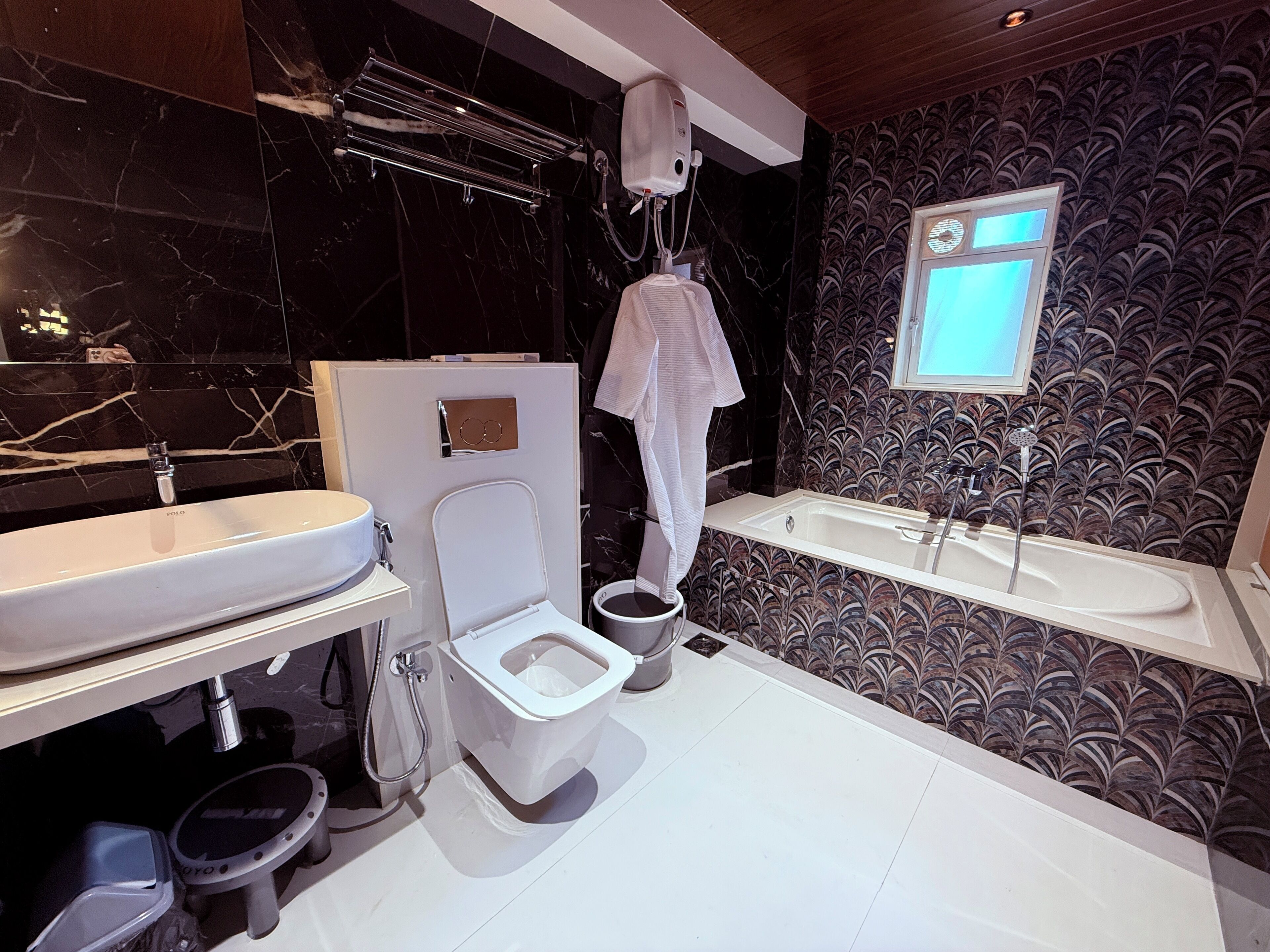 A modern bathroom with a toilet, bidet, and bathtub.